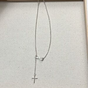 silver necklace with intertwined cross and infinity symbol